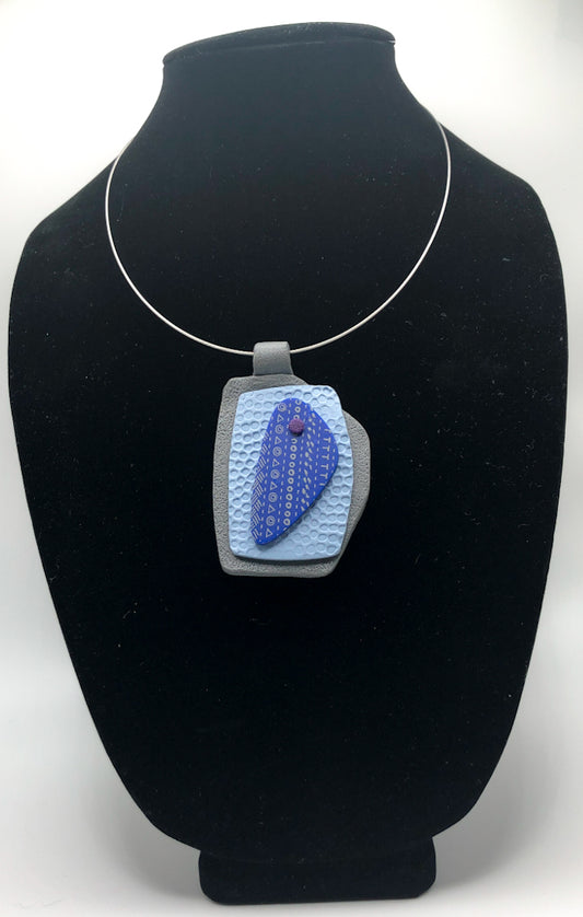 Painted design pendants in shades of blue, intricate texture,  unique shapes. 